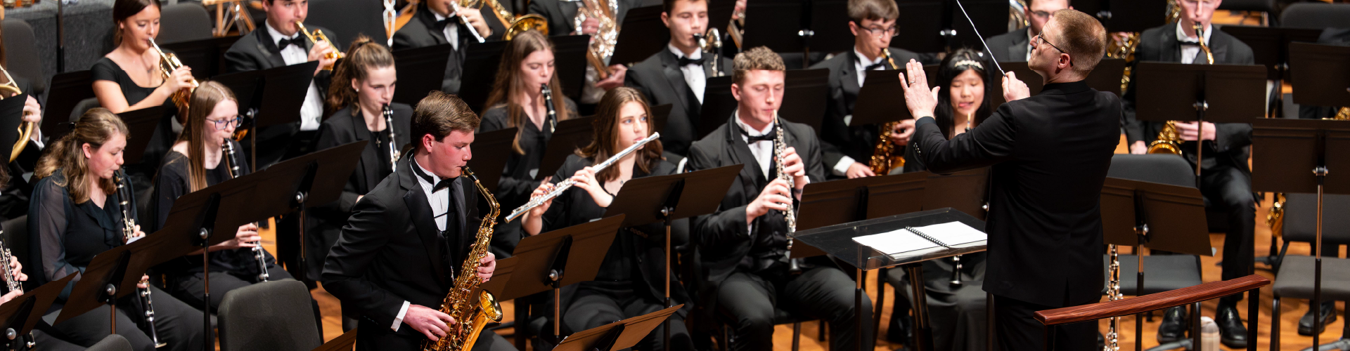 photo of saxophone player performing solo with band