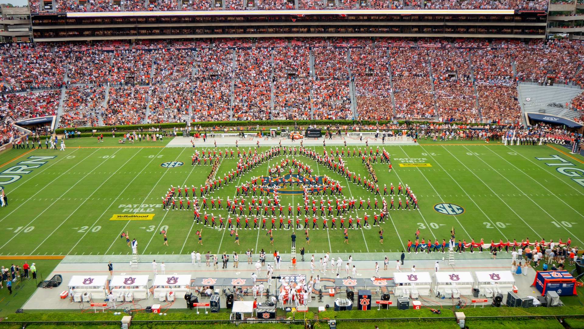 the Auburn University Marching Band forms the interlocking AU Logo on the field in Jordan-Hare Stadium